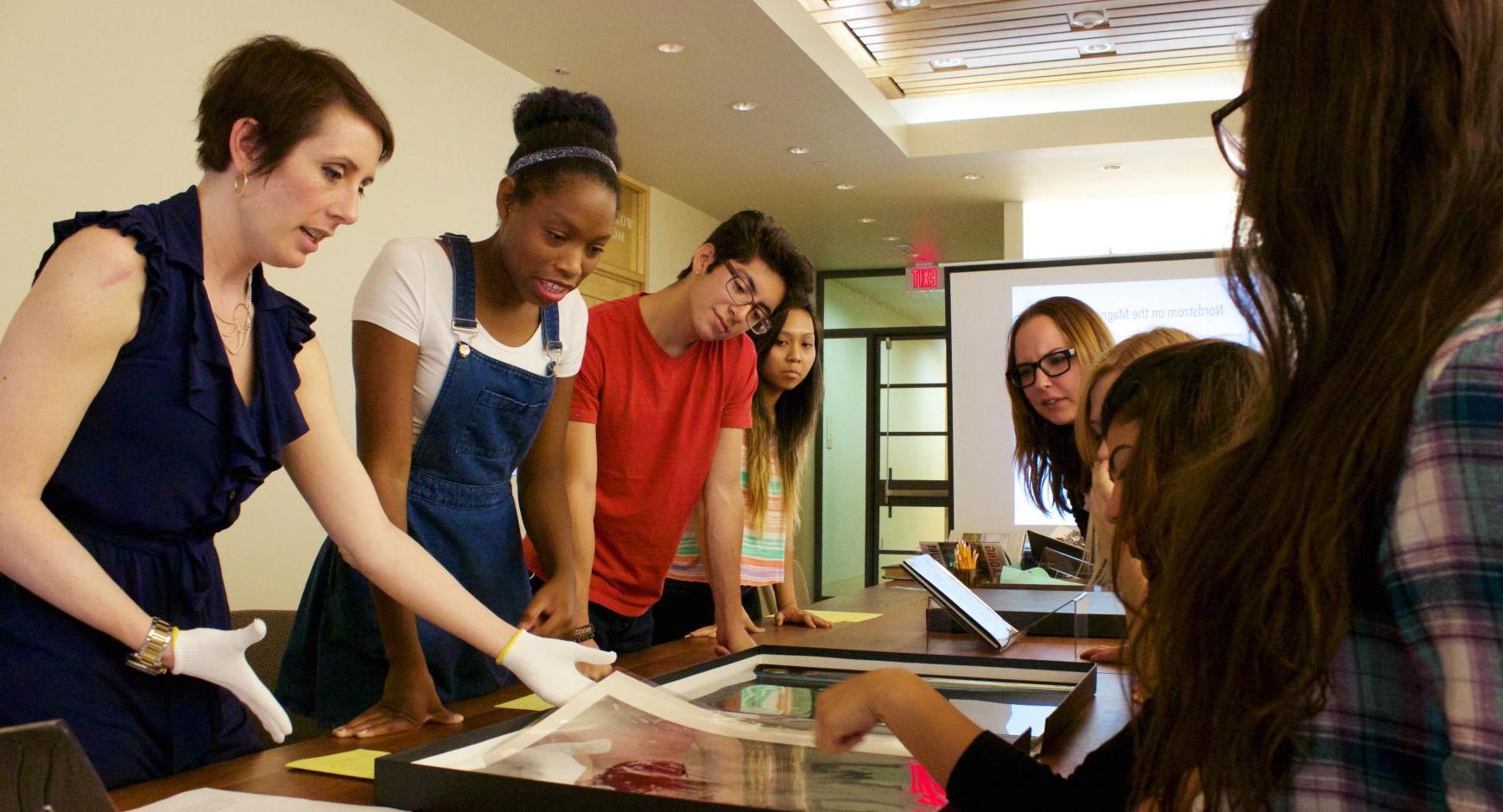 Students examine archival photos at the Harry Ransom Center